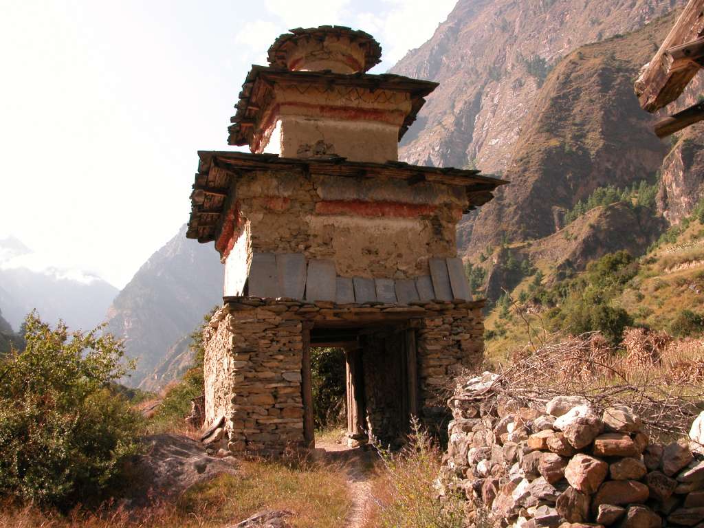 Manaslu 05 07 Ghap Kani I stopped and admired the Ghap (2110m) kani, with intricate, well-preserved paintings on the inside. A stone kani is a tall chorten in the form of an arch, the internal walls and ceiling of which are often decorated with Buddhist paintings.